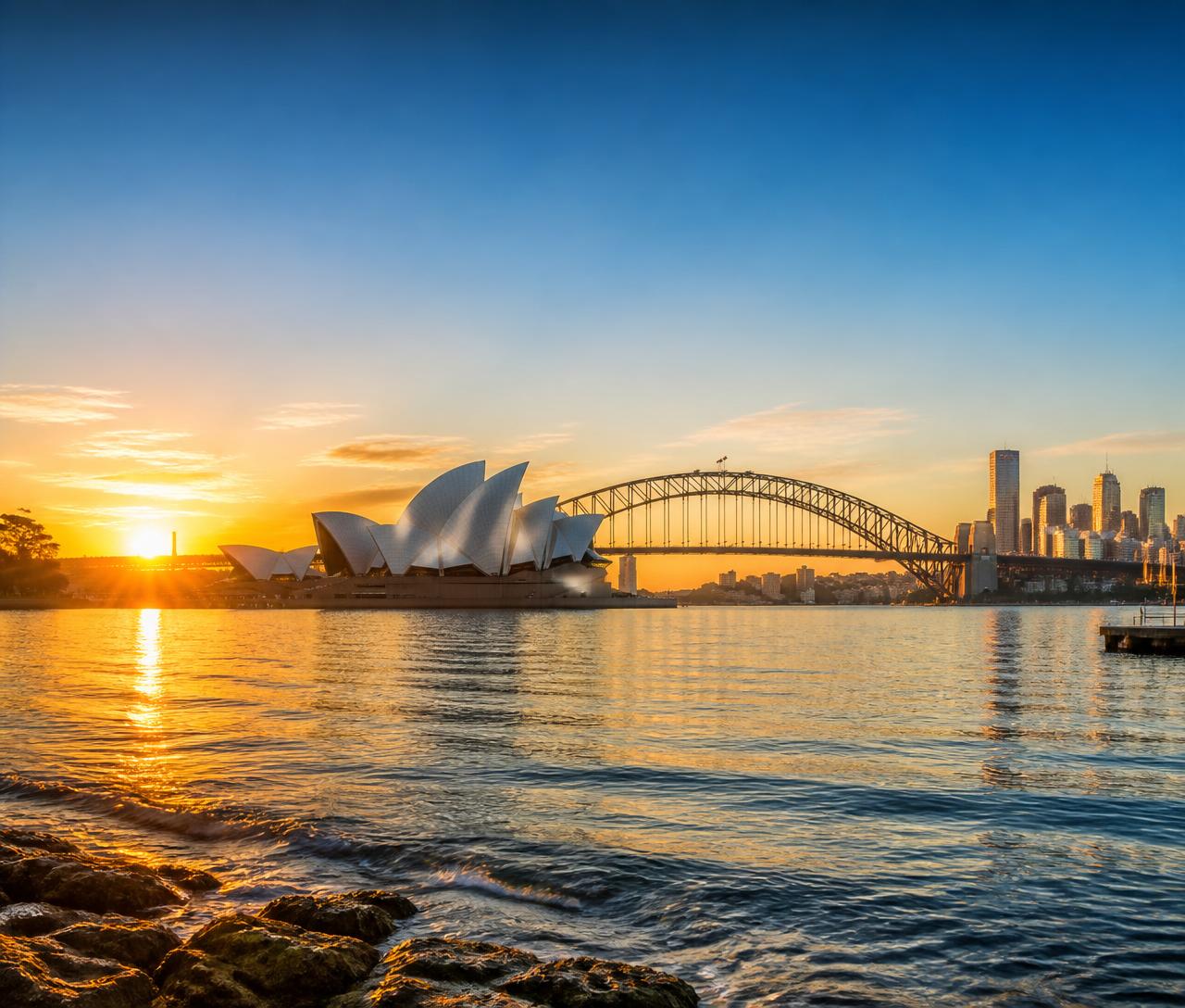 Sydney Opera House and Harbour Bridge at sunset with the city skyline